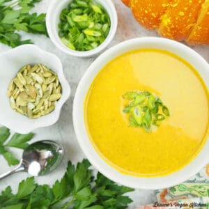 bowl of pumpkin ginger soup with pumpkin seeds and scallions