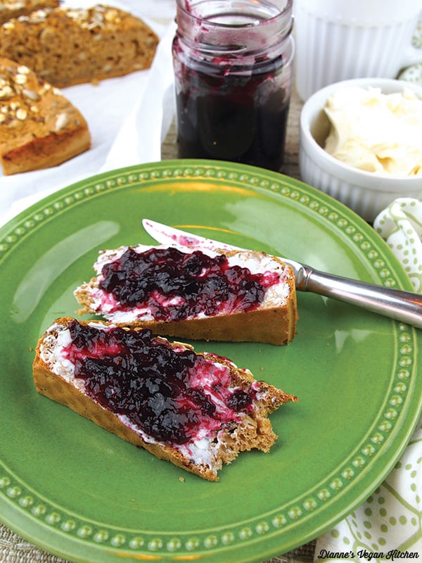 slices of Whole Wheat Soda Bread on plate with vegan butter and blueberry jam
