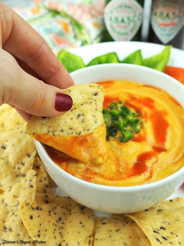 Dipping chips into vegan queso