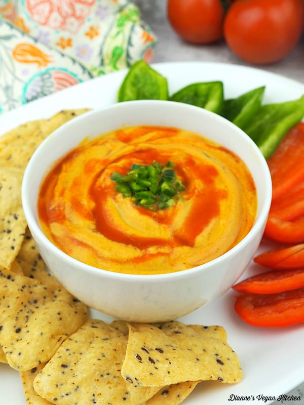 Vegan Queso with chips and cut peppers