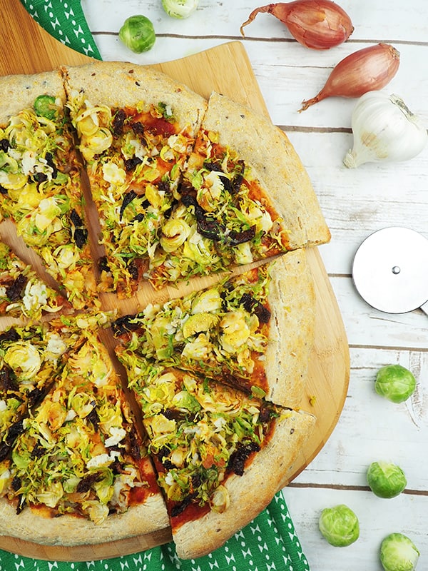 brussels sprouts pizza on pizza paddle vertical