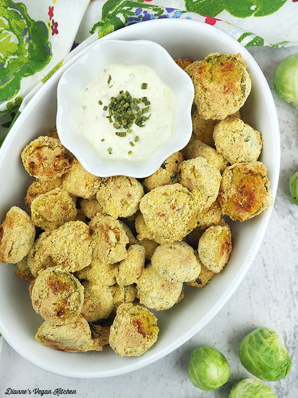 cornmeal crusted brussels sprouts in dish with dip