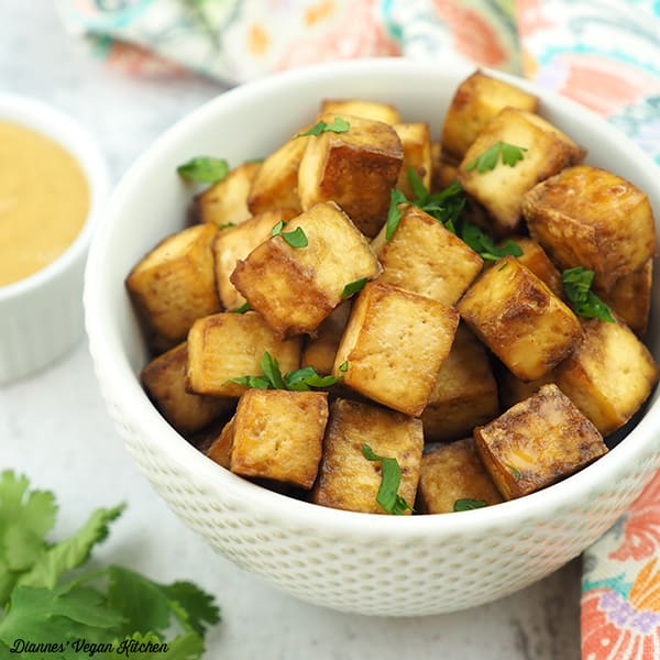 baked tofu in bowl with peanut dipping sauce square