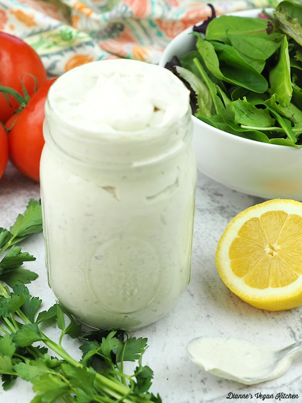 Tahini dressing jar with spoon on the side