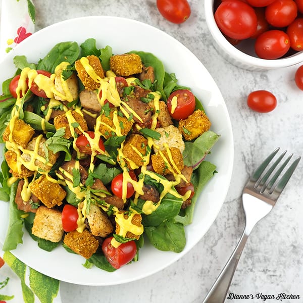 tofu benedict salad with tomatoes and fork