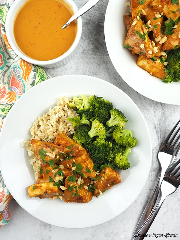 tofu on plates with brown rice and broccoli