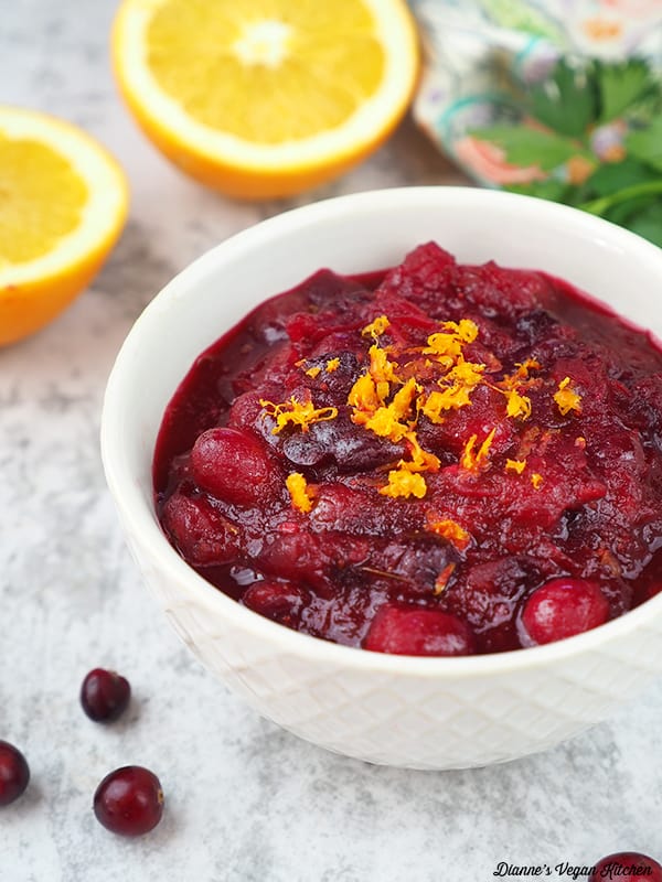 Cranberry sauce in bowl with oranges