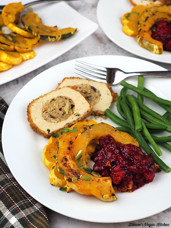 Plate with squash, cranberry sauce, green beans, and roast