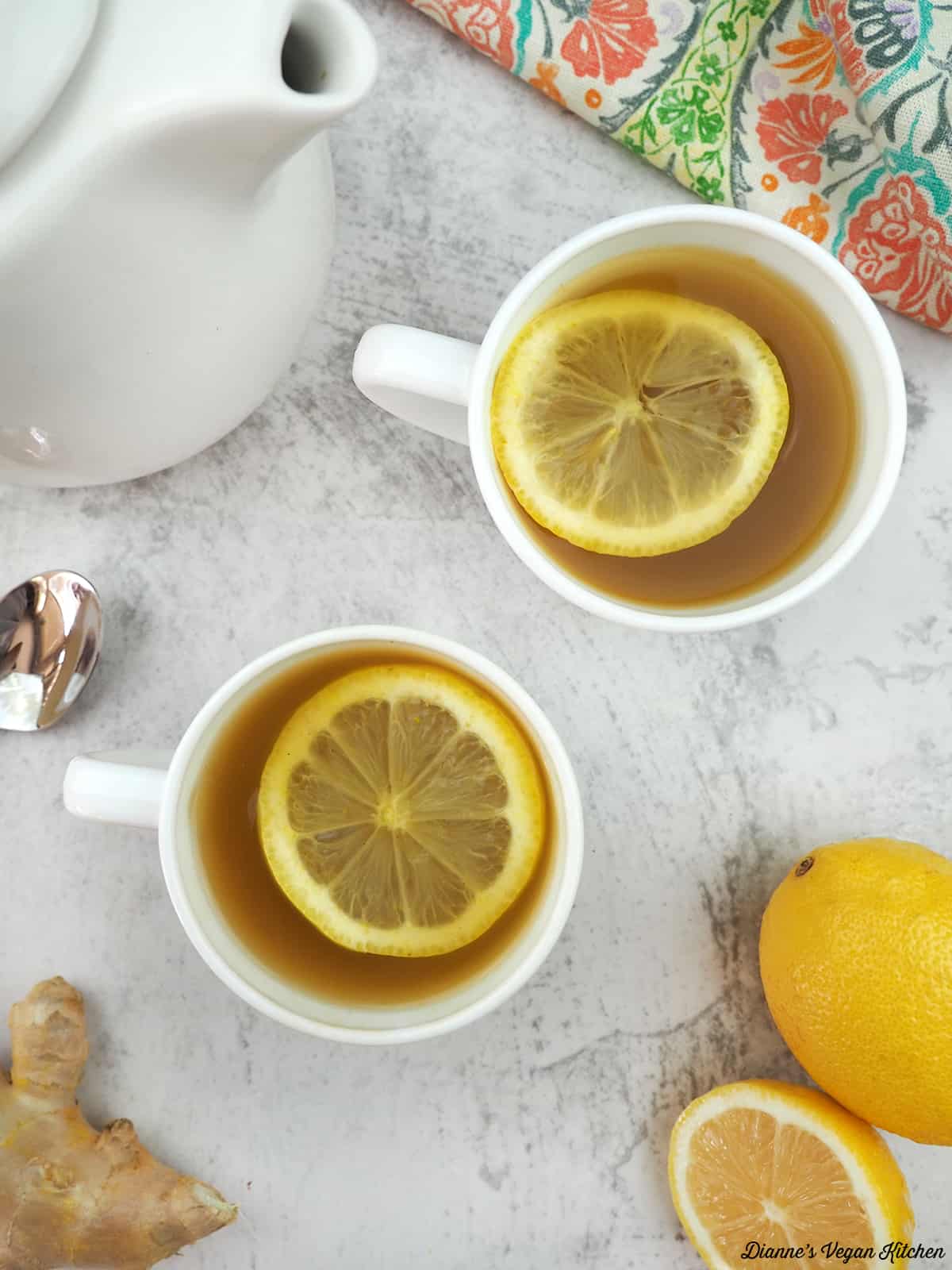 two mugs of sinus buster tea overhead with lemon slices