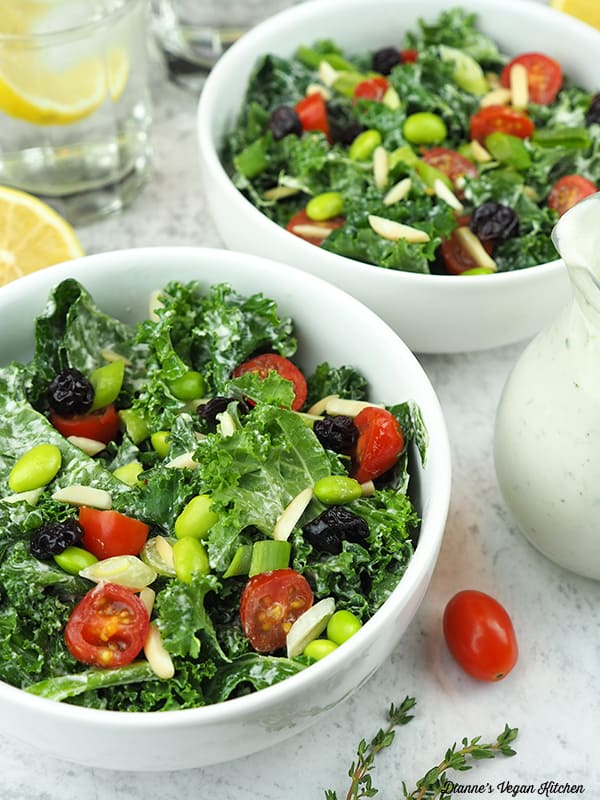 Kale and Edamame Salad in bowls with dressing