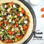 vegan greek pizza on pan with text overlay