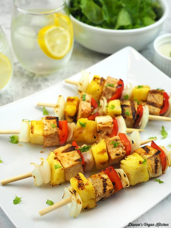 Grilled Tofu Skewers on plate with salad and water