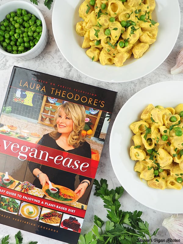 Laura Theodore's Vegan Ease book with two bowls of mac and pease