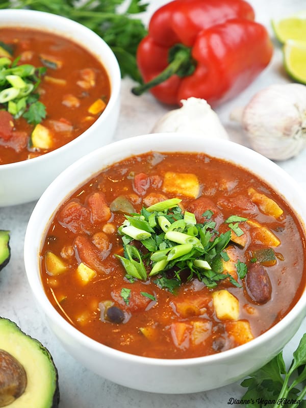 two bowls of Three Bean Chili with peppers and avocado
