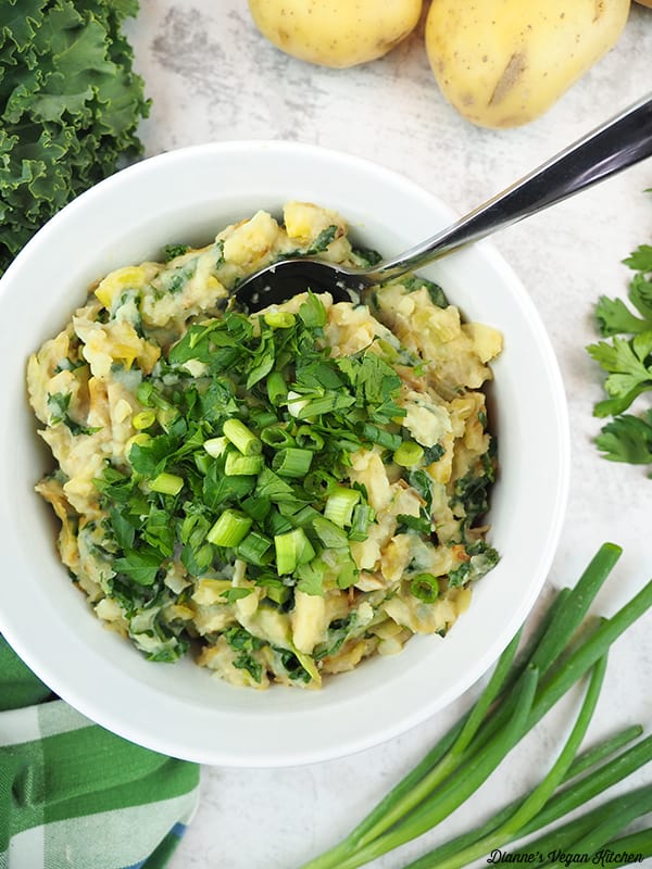 colcannon with spoon, potatoes, scallions, parsley, and kale