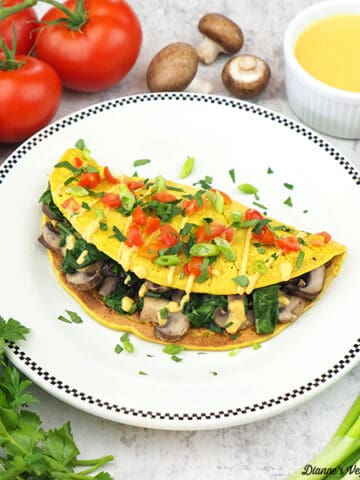chickpea omelet with tomatoes, mushrooms, and cheese sauce—square