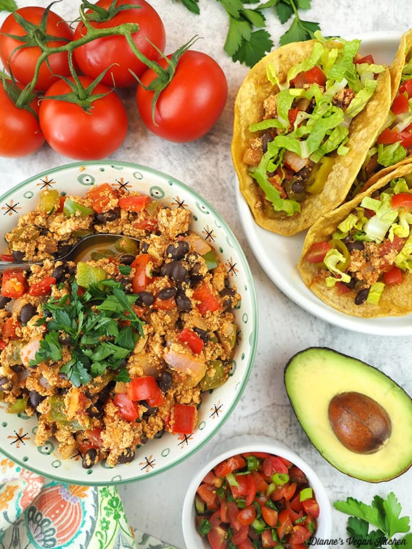 tacos with tomatoes, avocado, and bowl of chorizo