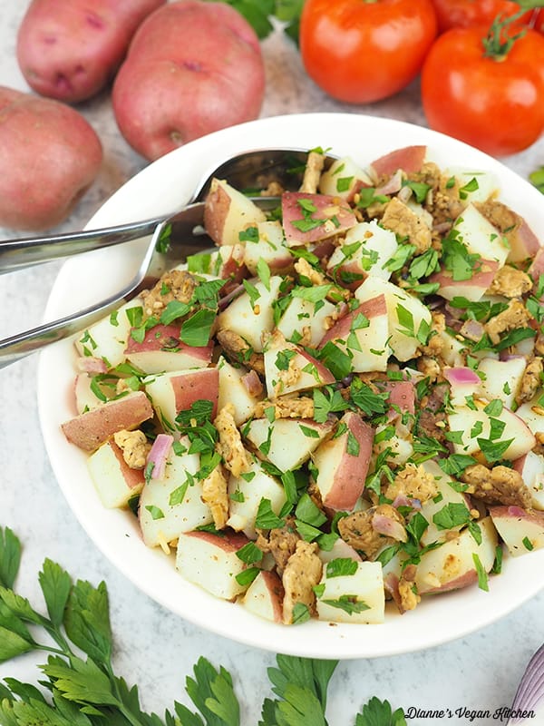 bowl of potato salad with fork and spoon