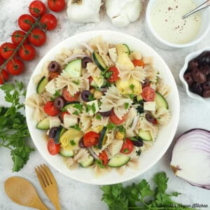Vegan Greek Pasta Salad with tomatoes, garlic, onion, tahini, olives, and parsley square