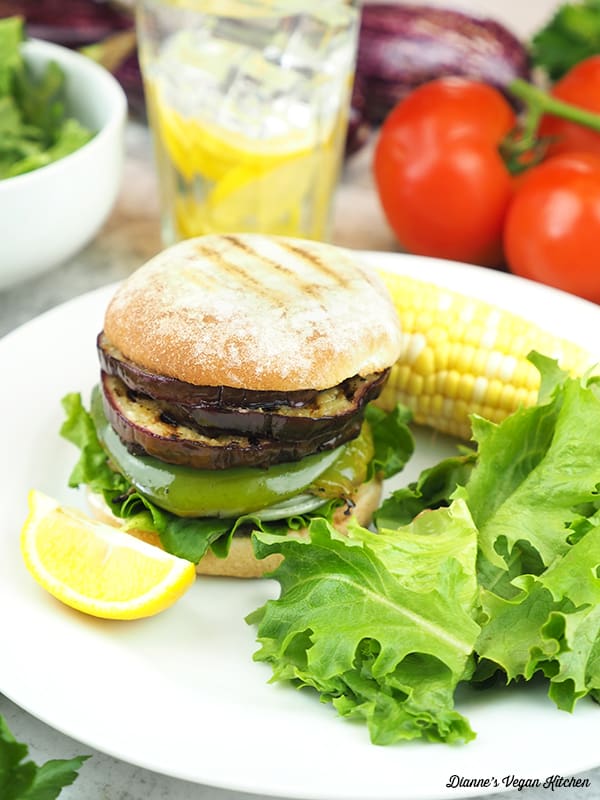 Grilled Eggplant Sandwich on plate with corn on the cob and salad