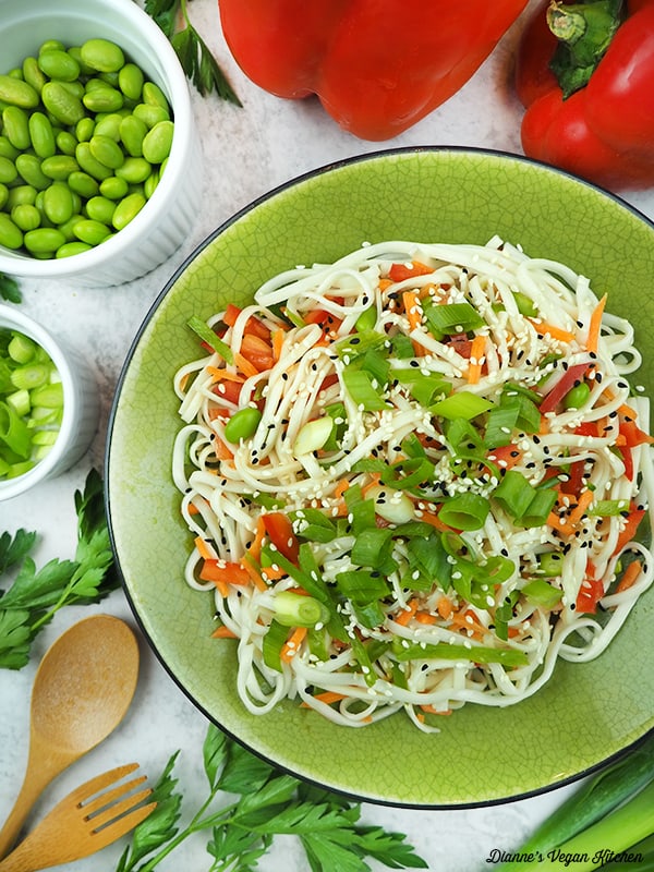 bowl of noodles with edamame, peppers and scallions
