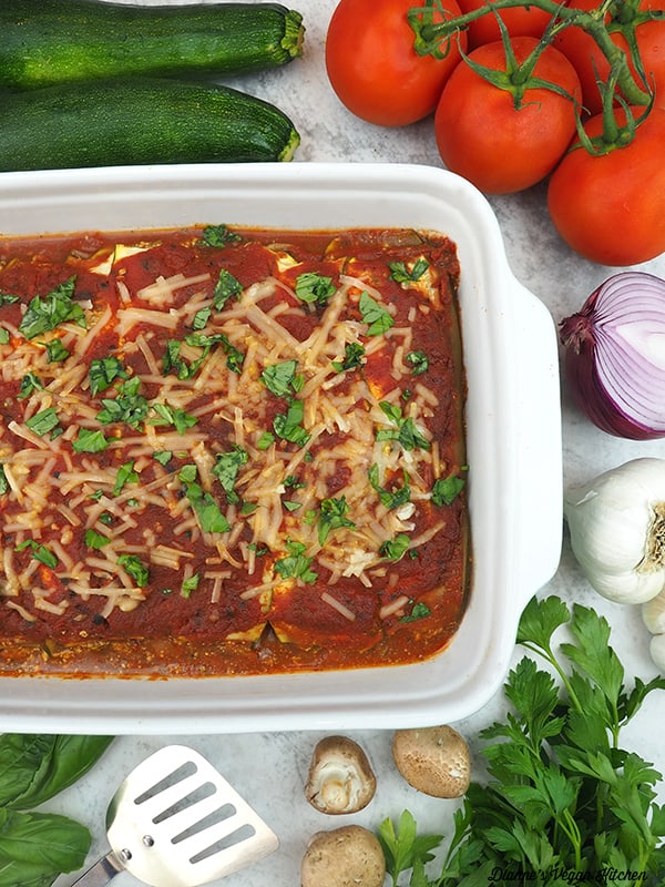 pan of Vegan Zucchini Lasagna with tomatoes, zucchini, onion, garlic, and mushrooms