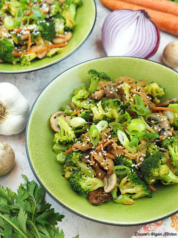 two bowls of Soy Curl Stir-Fry with onion, garlic, carrots and mushrooms