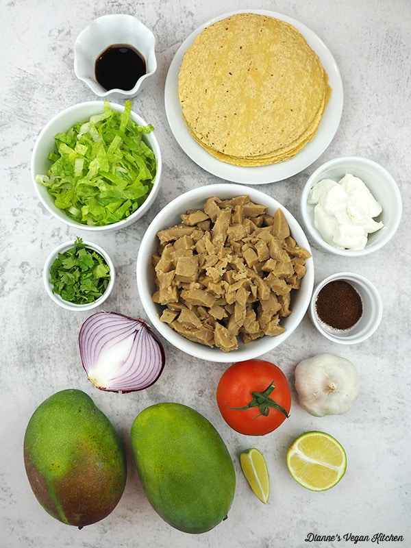 tortillas, seitan, mayo, chipotle powder, limes, garlic, tomato, onion, mango, cilantro, lettuce, soy sauce
