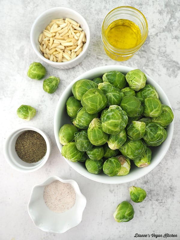 uncooked sprouts with almonds, salt, pepper, and oil