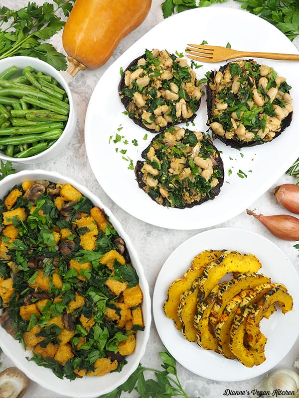 stuffed portobellos with dish of stuffing, green beans, and squash