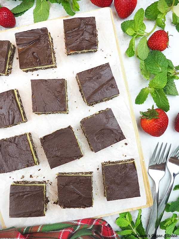 plate of bars with strawberries and mint leaves