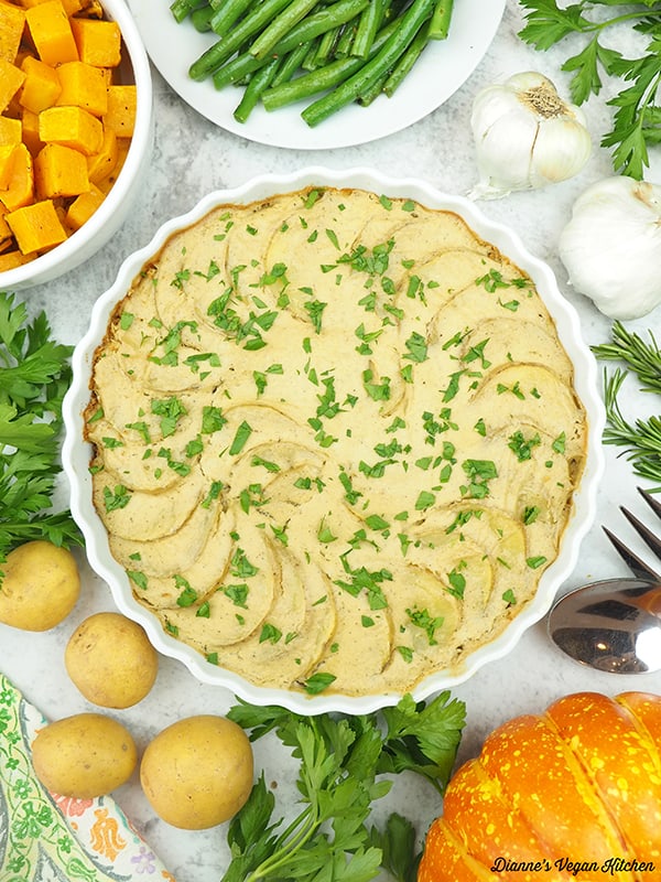 Vegan Scalloped Potatoes with squash, green beans, garlic, and herbs