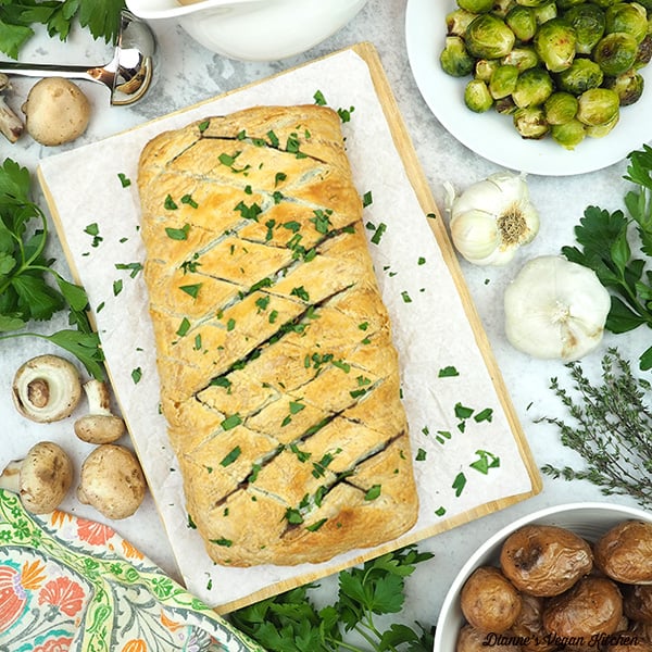 mushroom wellington with roasted brussels sprouts, roasted potatoes, gravy, and garlic