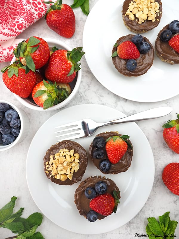 two plates of tarts with berries