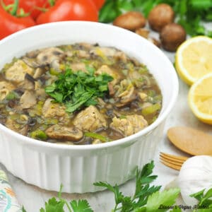 serving bowl of fricassee with tomatoes, lemon, mushrooms, and garlic