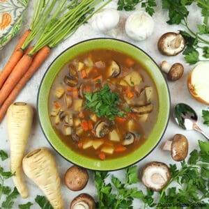 one bowl of vegan irish stew with garlic, onion, mushrooms, parsnips, and carrots