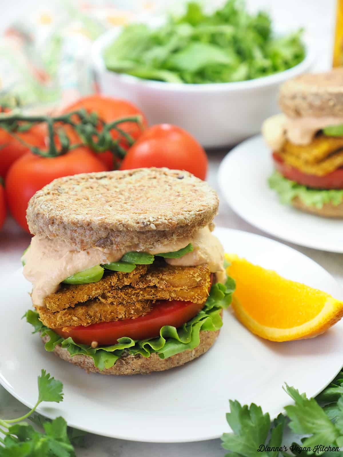 breakfast sandwich with orange, tomatoes, and lettuce