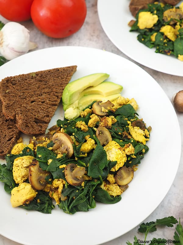 close up of plate of tofu scramble with avocado and toast
