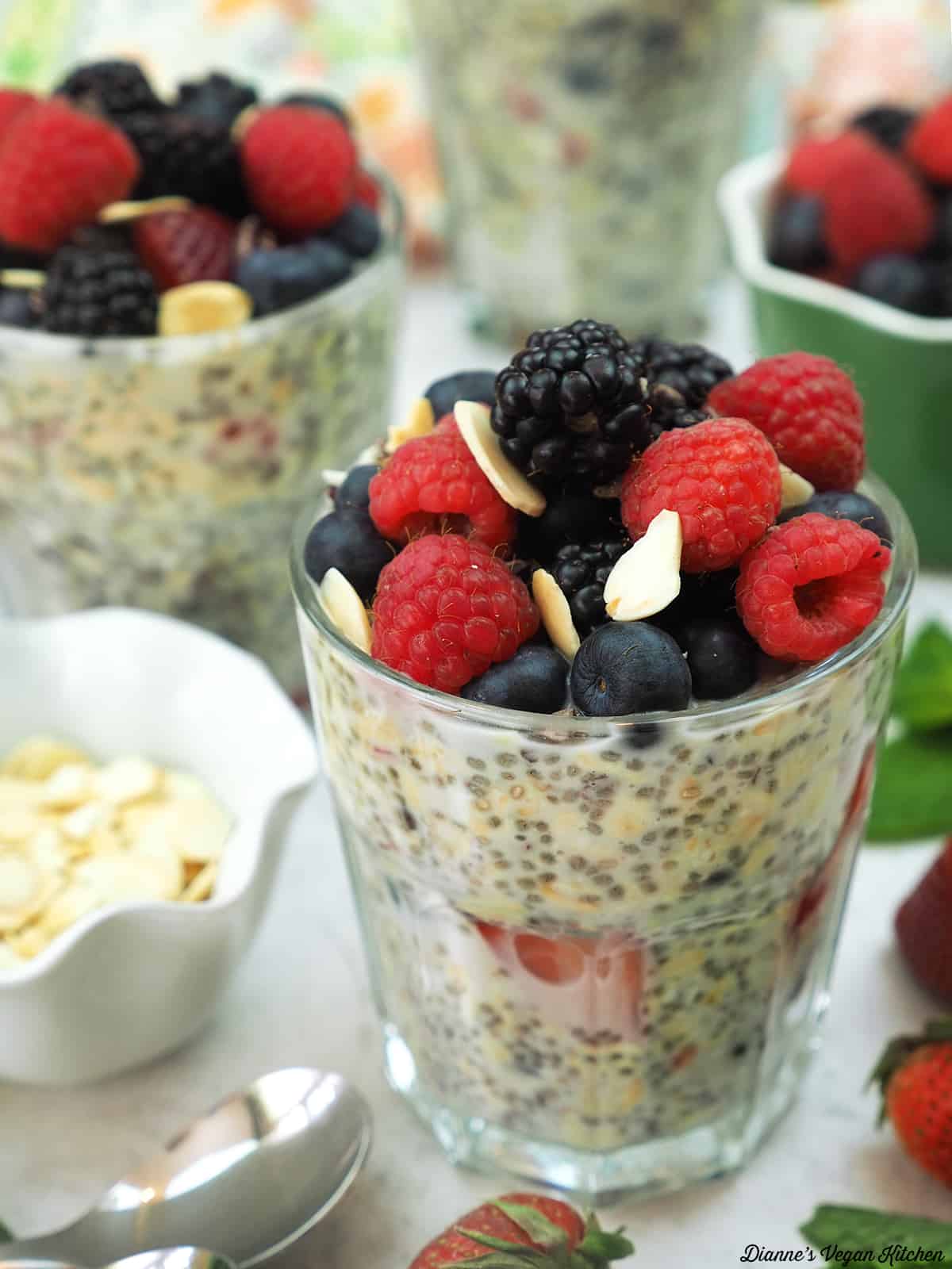 overnight oats with berries, spoon, and almond slivers