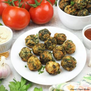 Kale and Potato Nuggets square with tomatoes, dip, garlic, and fork