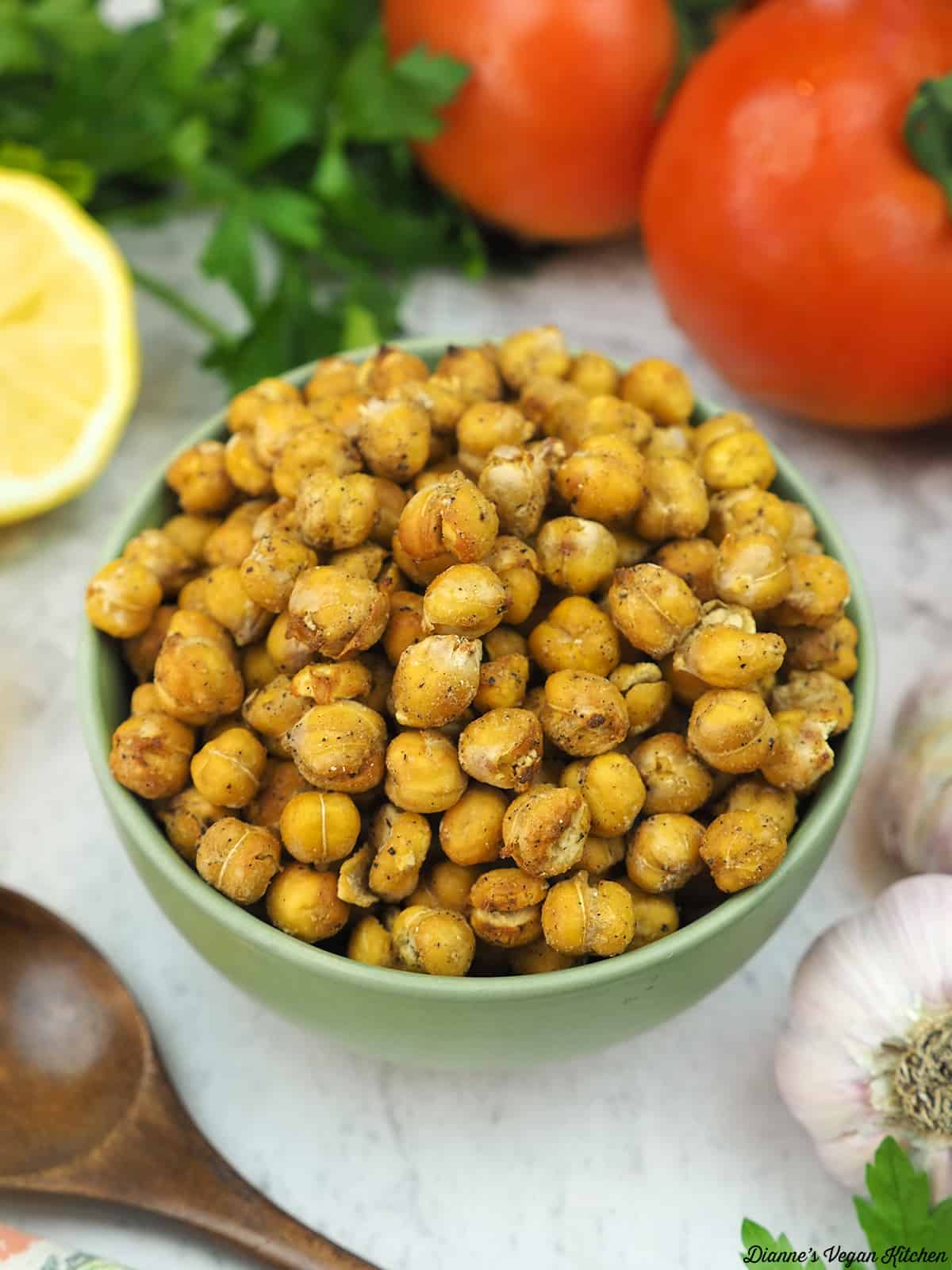 bowl of roasted chickpeas with tomato, lemon, and garlic