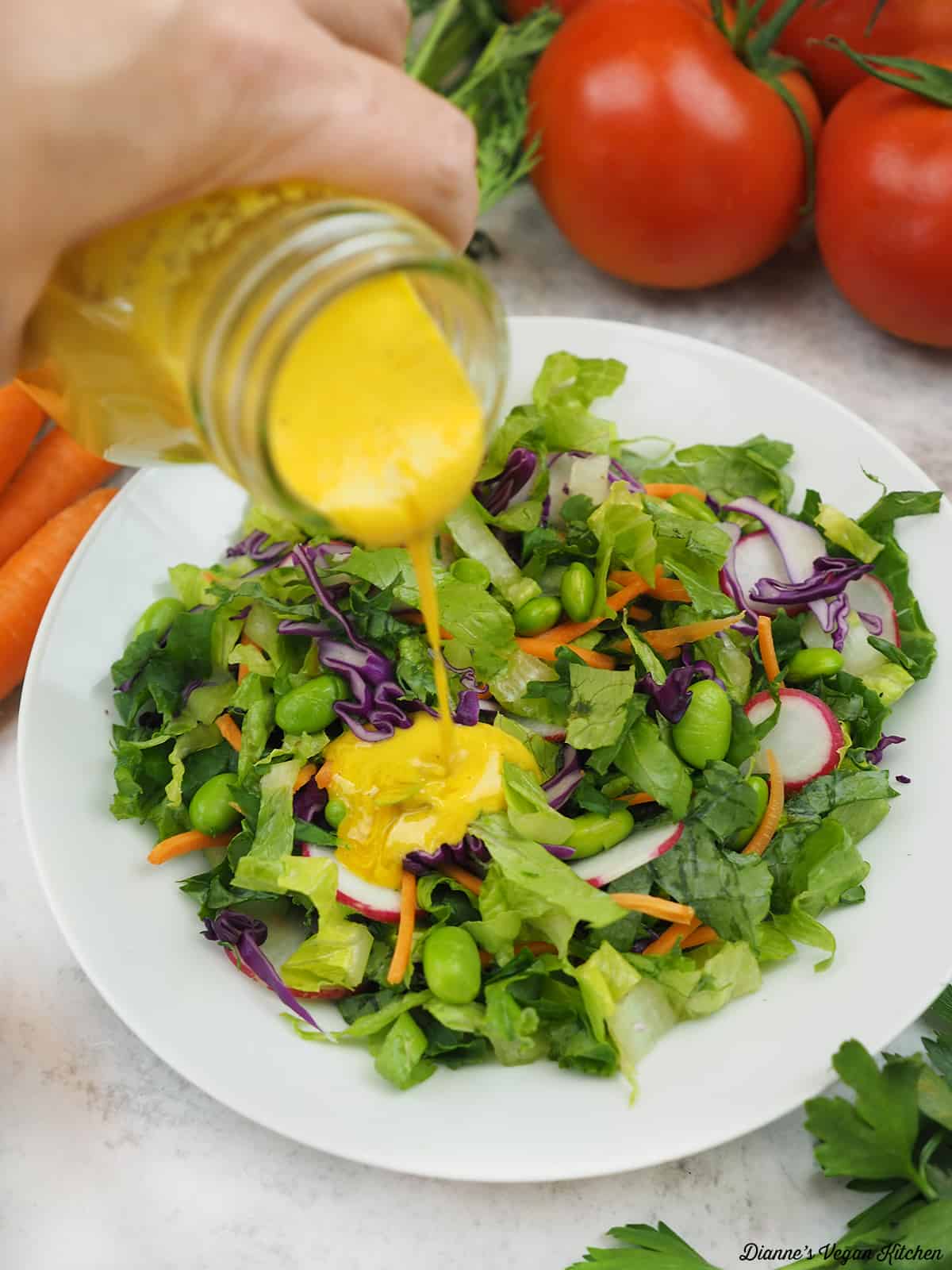 pouring dressing over salad