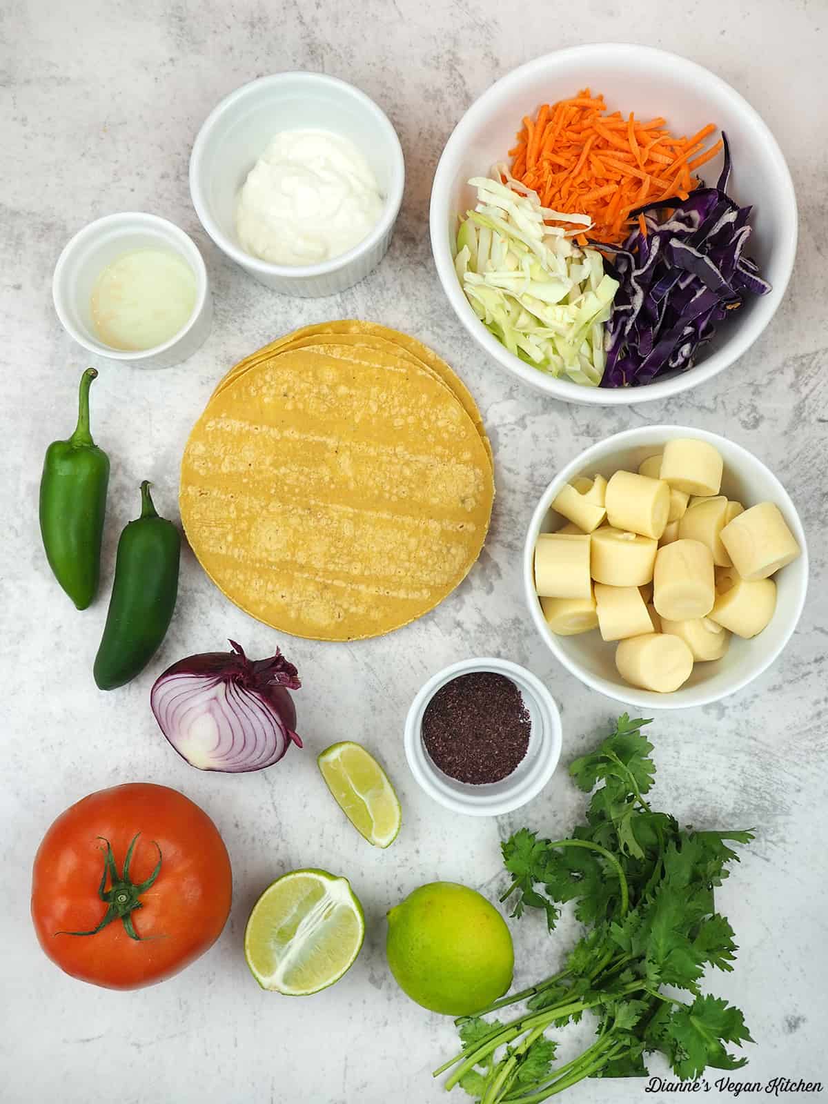 vinegar, vegan mayo, carrots and cabbage, hearts of palm, tortillas, seaweed flakes, jalapeno, tomatoes, onion, limes, and cilantro