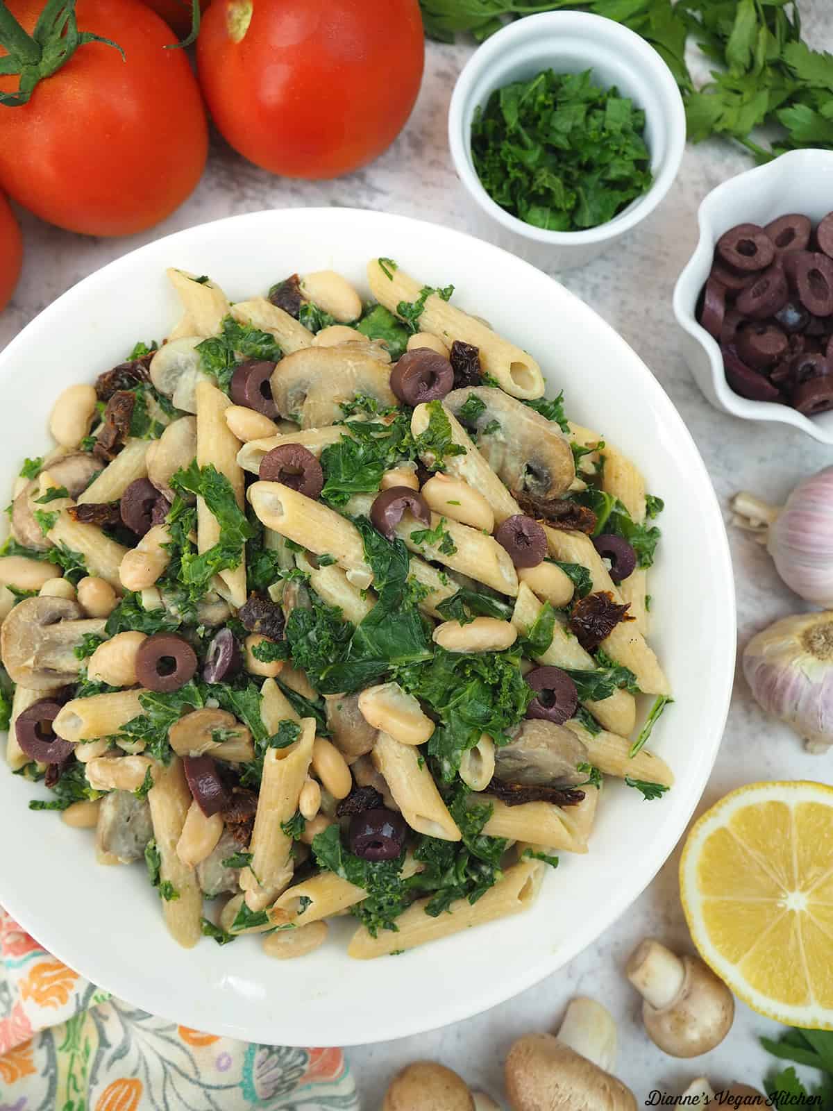Creamy Vegan Pasta with tomatoes, parsley, olives, and mushrooms