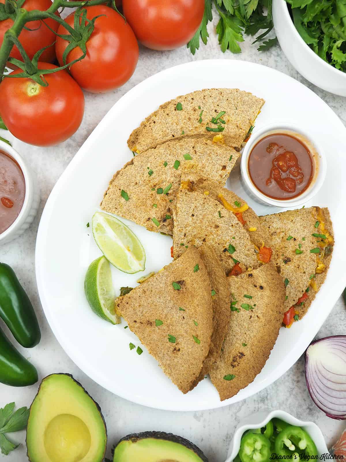 platter with quesadillas with salsa, tomatoes, peppers, and avocado