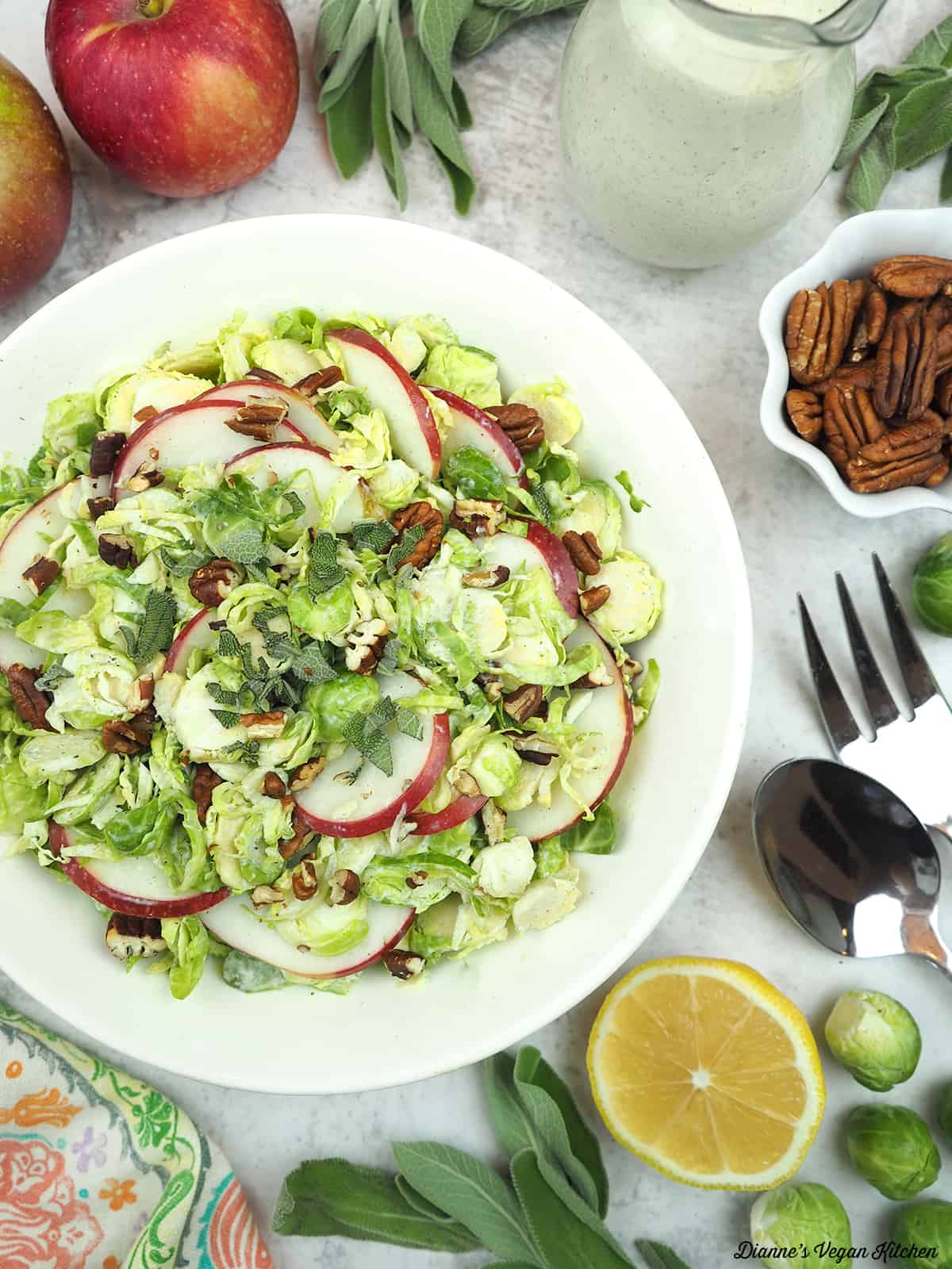 Shaved Brussels Sprout with apples, dressing, sage, pecans, and lemon