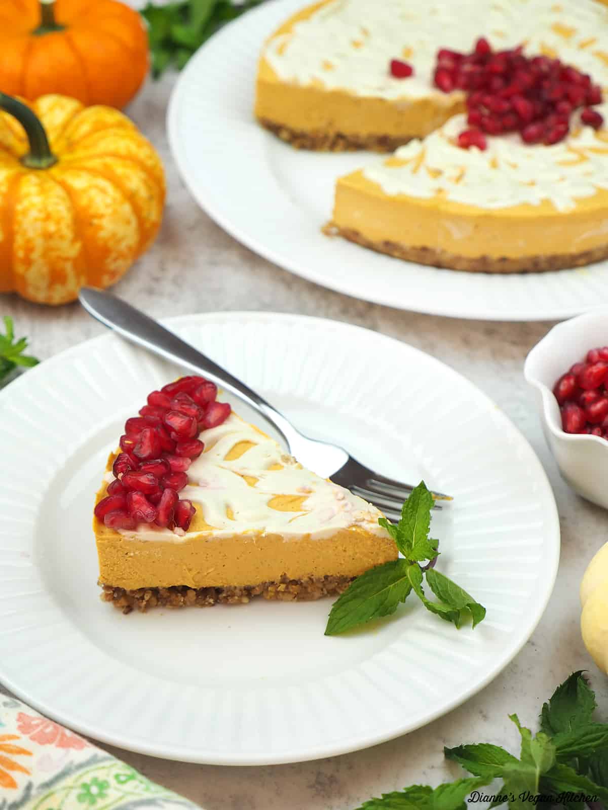 slice of cheesecake with pumpkins and pomegranate seeds