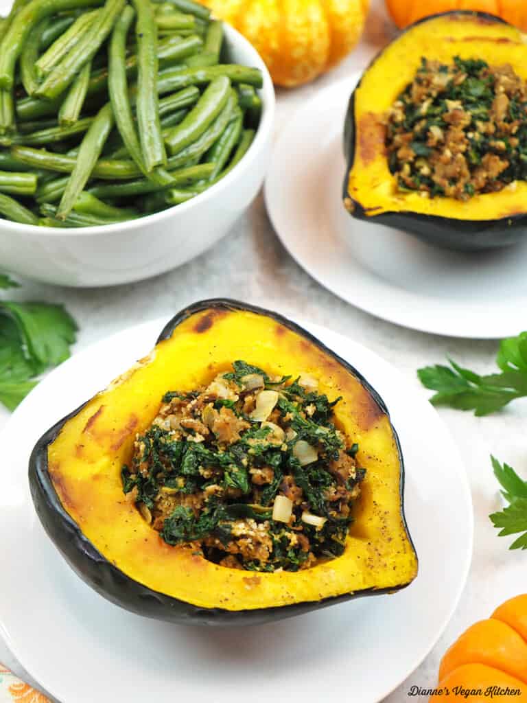 two plates of stuffed squash and a bowl of green beans
