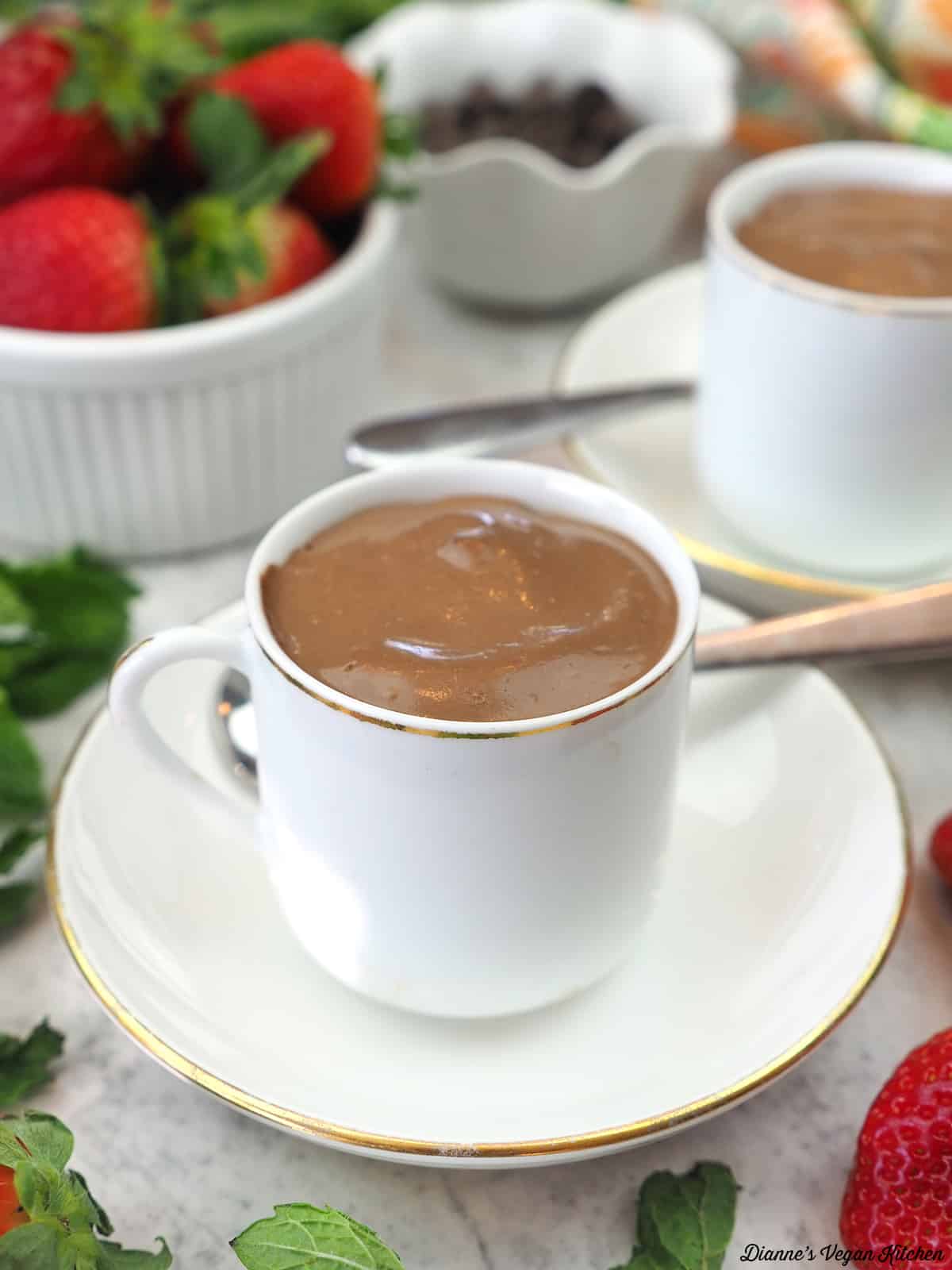 two cups of pots de creme with strawberries