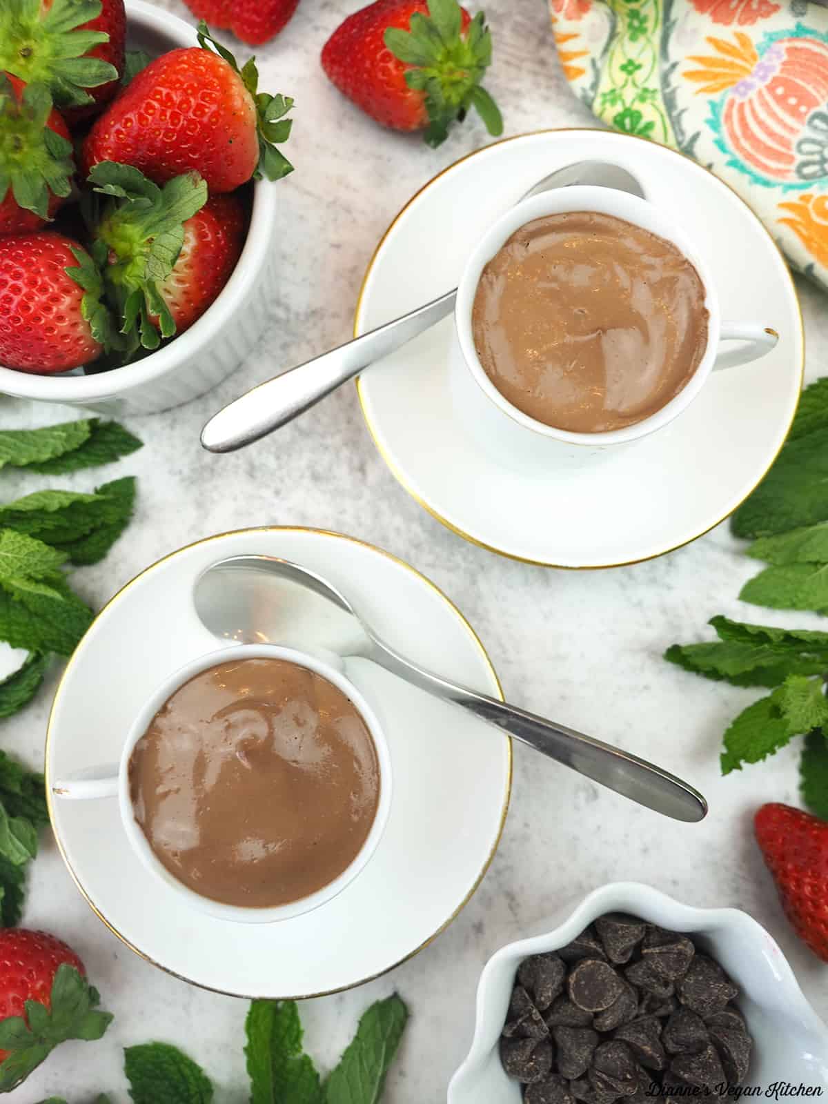 two cups of pots de creme overhead with strawberries